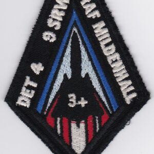 A patch with a red, white and blue design.