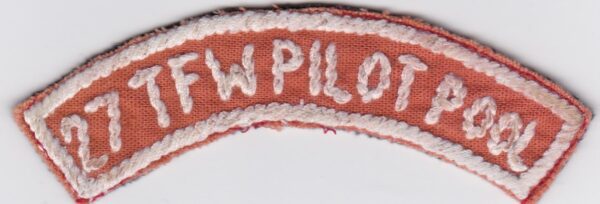 An orange and white embroidered patch.