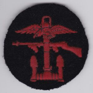 A British Commando WWII Patch Combined Operations Red Black Disc b with an eagle and a gun.